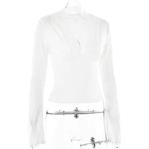 Elegant white long sleeve top featuring a deep V-neckline with intricate lace trim details
