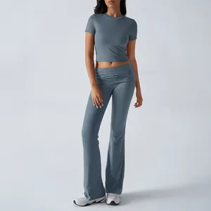 Full length view of a dusty blue two-piece yoga set with crop top and flare leggings