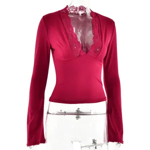 Macro view showing the sexy deep V-neck and delicate lace trim on red long-sleeve top.