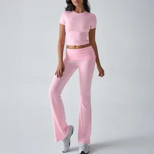 Detail view of a pink two-piece sportswear set including a crop top and flared leggings.