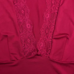 Close-up view of the delicate floral lace splicing on this deep red V-neck knit top