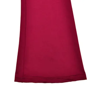 Close-up detail of the double-stitched hem on a burgundy long sleeve lace top garment