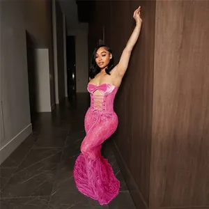 Full view detail of a vibrant pink lace strapless maxi dress with corset lace-up front
