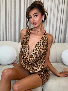 Stunning leopard print two-piece set featuring halter neck top and matching mini skirt.