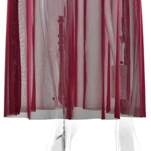Macro view of elegant burgundy mesh pleated sheer fabric detail on a solid dress