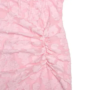 Close-up detail of pink lace texture and ruched design on a sexy bodycon dress
