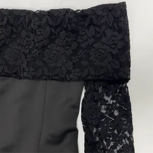 Detailed macro view of an elegant black off-the-shoulder dress with rose jacquard lace