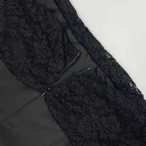 Close-up of invisible zipper and intricate black jacquard lace on elegant dress