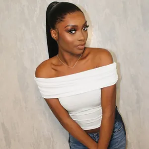 Detail showing a white off-the-shoulder cropped top with ruched neckline on a model