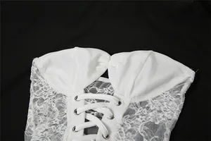 Close-up of white lace-up mesh corset detail on elegant tube long dress