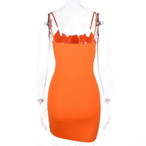 Back view of a vibrant orange camisole mini dress with ribbed texture on a mannequin.