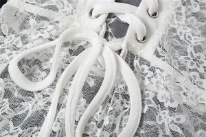 Macro close-up showing delicate white floral lace mesh and ribbon tie-up detail.