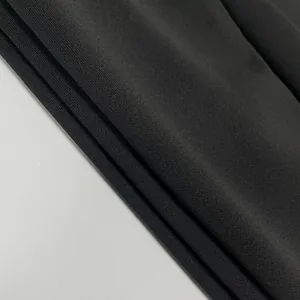 Macro detail of high-quality black textured fabric for elegant off-the-shoulder evening dress