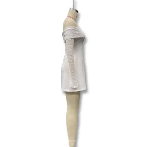 Side view of an elegant off-the-shoulder white lace dress on a dress form mannequin