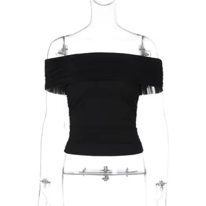 Close-up front view of a black off-the-shoulder ruched cropped top on a mannequin