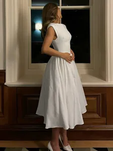 Detailed view of an elegant white French-style dress with fly sleeves and full skirt