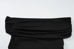 Close-up detail view of the elegant ruched boat neck on a minimalist black crop top.