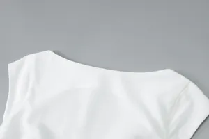 Close-up of elegant boat neckline and smooth fabric on a white French summer dress