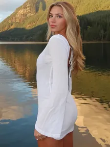 Detail view of white backless mini dress with elegant tie-up design and flare sleeves.