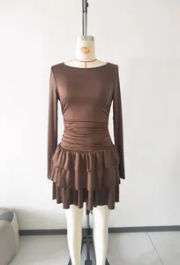 Detailed view of brown slim fit long sleeve dress featuring tiered ruffled skirt on mannequin