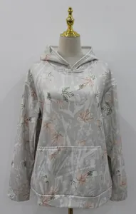 Detailed view of women's oversized camo hoodie with maple leaf print and pocket