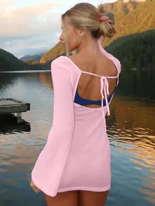 Detailed back view of a pink summer dress featuring tie-back hollow design and flared sleeves