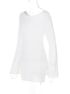Detailed view of white mini dress featuring elegant flare sleeves and round neck.