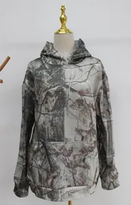 Detailed view of women's oversized camouflage hoodie with maple leaf pattern and pocket