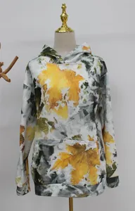 Detailed view of oversized women's hoodie featuring autumn maple leaf camouflage print