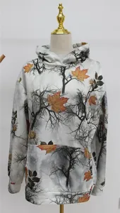 Front view of women's oversized hoodie featuring a woodland maple leaf camouflage print