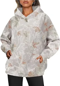 Detail view of women's oversized maple leaf camouflage hoodie with kangaroo pocket