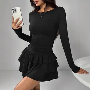 Elegant slim-fit black long-sleeved dress with ruffled hem and ruched waist for autumn
