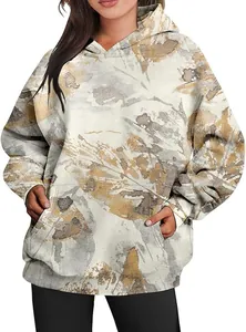 Detail view of the autumn camouflage maple leaf print on an oversized women's hoodie