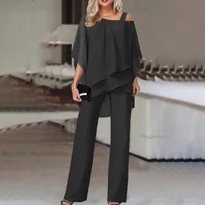 Detail view of the elegant black off-shoulder batwing sleeve top and wide-leg trousers set