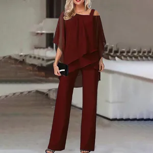 Elegant burgundy two-piece set with off-shoulder batwing top and straight trousers on model