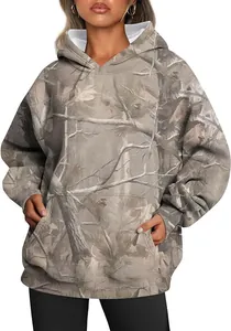Close-up of women's oversized camo hoodie with maple leaf print and front pocket detail