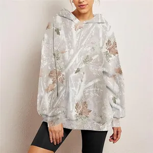 Oversized women's hoodie with gray and brown maple leaf camouflage print on model.