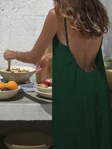 Detailansicht der Rückseite eines dunkelgrünen, rückenfreien Maxikleides mit Spaghettiträgern