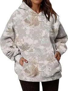 Detail view of women's oversized hoodie with maple leaf camouflage print and front pocket