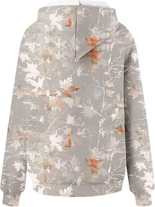 Back view detail of women's oversized hoodie with autumn maple leaf camouflage print