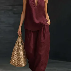 Close-up of elegant burgundy linen sleeveless top and loose wide-leg pants summer set