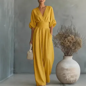 Elegant mustard yellow V-neck wide-leg jumpsuit with cinched waist for women.