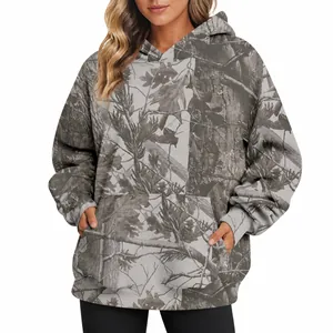 Close-up of women's oversized camouflage hoodie with maple leaf print and front pocket