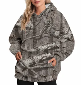 Detail view of women's oversized camouflage hoodie with realistic leaf and tree print