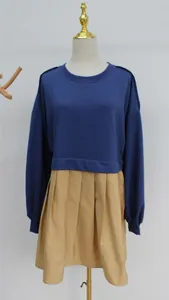 Close-up detail of the fake two-piece blue sweatshirt and khaki pleated skirt dress on mannequin.