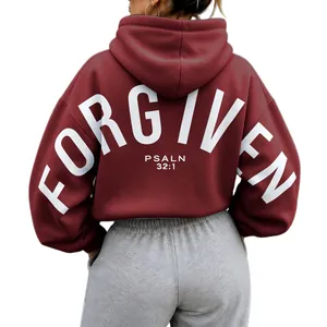 Back view of oversized burgundy hoodie with white Forgiven Psalm 32:1 letter print