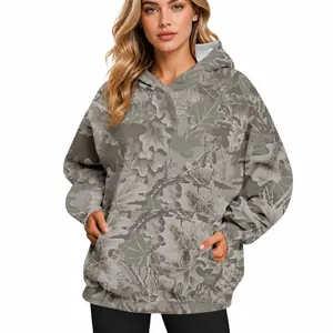 Women's oversized camouflage hoodie featuring an intricate maple leaf print and front pocket