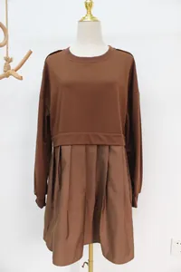 Close-up detail of a brown fake two-piece sweatshirt dress featuring a pleated skirt