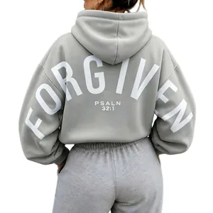 Detail of oversized gray hoodie featuring white 'FORGIVEN PSALM 32:1' back print.