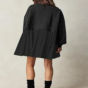 Back view of a casual black long-sleeved sweatshirt dress with a pleated ruffle hem
